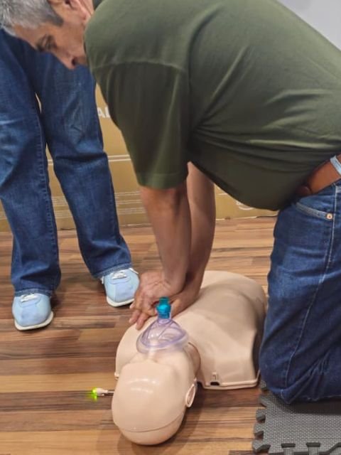 a man training on dummy in CPR class in Charlotte