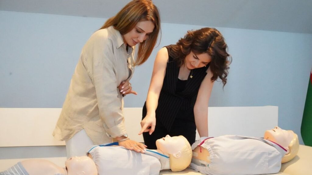 two people working on a dummy for cpr practice