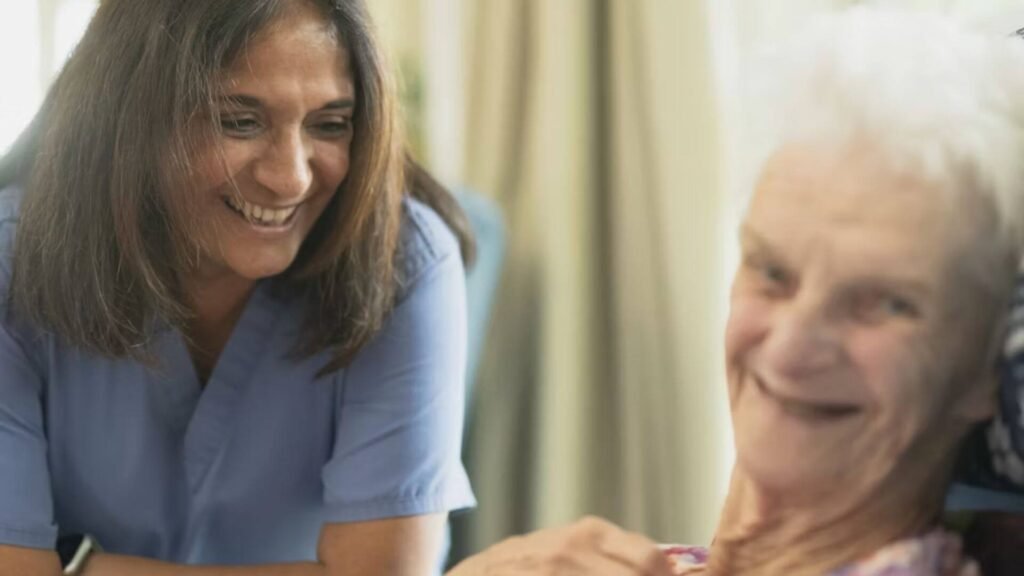 woman smiling with older woman into camera